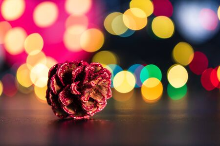 Christmas decoration and ornaments. Christmas composition on blurred lights background.Christmas pine cone.の写真素材