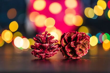 Christmas decoration and ornaments. Christmas composition on blurred lights background.Christmas pine cone.の写真素材
