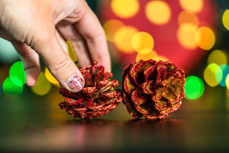 Christmas decoration and ornaments. Christmas composition on blurred lights background. hand putting...