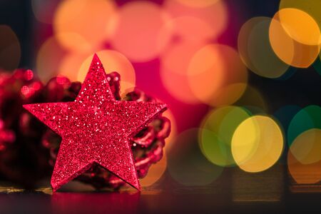 Christmas decoration and ornaments. Christmas composition on blurred lights background. Red and glittery decorations.の写真素材