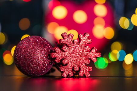 Christmas decoration and ornaments. Christmas composition on blurred lights background. Red and glittery decorations.の写真素材