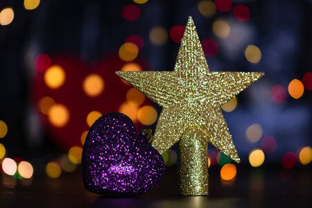 Christmas decoration and ornaments. Christmas composition on blurred lights background. Shiny Christmas topper.の写真素材