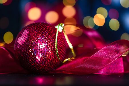 Christmas decoration and ornaments. Christmas composition on blurred lights background. Shiny Christmas ball.の写真素材