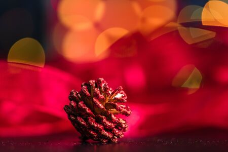 Christmas decoration and ornaments. Christmas composition on blurred lights background.Christmas pine cone.の写真素材