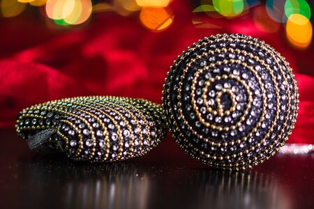 Christmas decoration and ornaments. Christmas composition on blurred lights background. Black and shiny Christmas balls.の写真素材