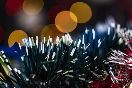 Christmas decoration and ornaments. Christmas composition on blurred lights background. Colorful Christmas garland.の写真素材
