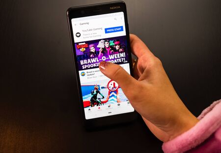 Woman holding a Nokia phone with social Internet service YouTube on the screen in Bucharest, Romania, 2019のeditorial素材