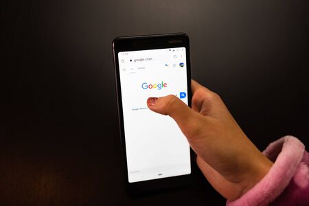 Woman holding a Nokia phone with Google Internet service on the screen in Bucharest, Romania, 2019のeditorial素材