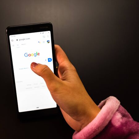 Woman holding a Nokia phone with Google Internet service on the screen in Bucharest, Romania, 2019のeditorial素材