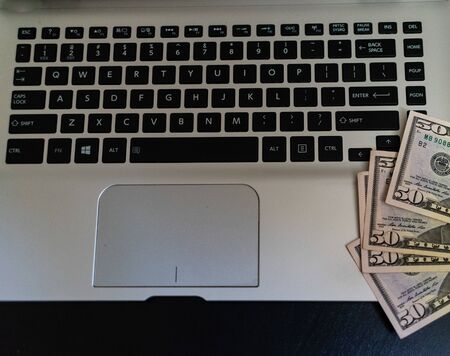 Top view of money on keyboard. Dollars money on keyboard.の写真素材