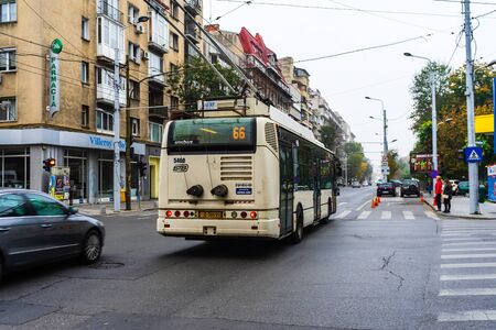 Traffic on the main boulevard in downtown Bucharest. Junction with stopped cars waiting for green light in Bucharest, Romania, 2019のeditorial素材