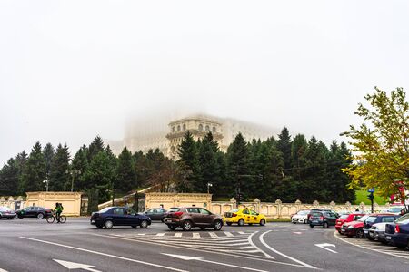 Traffic on the main boulevard in downtown Bucharest. Parliament Palace covered in fog, morning in Bucharest, Romania, 2019のeditorial素材