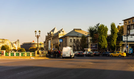 Traffic on the main boulevard in downtown Bucharest. Junction with stopped cars waiting for green light in Bucharest, Romania, 2019のeditorial素材
