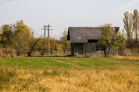 Old abandoned house in autumn. Autumn day, autumn season.の写真素材