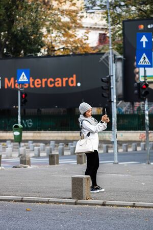 Asian tourist woman taking a photo in downtown Bucharest, Romania, 2019のeditorial素材