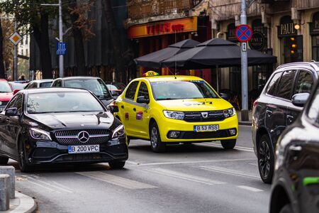 Traffic on the main boulevard in downtown Bucharest. Junction with stopped cars waiting for green light in Bucharest, Romania, 2019のeditorial素材