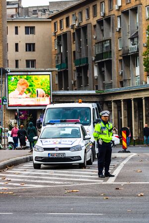 Police agent directing traffic during the morning rush hour in downtown Bucharest, Romania, 2019のeditorial素材