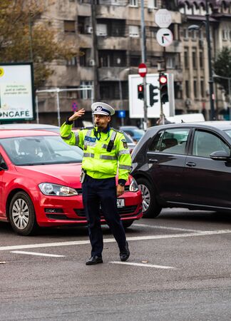 Police agent directing traffic during the morning rush hour in downtown Bucharest, Romania, 2019のeditorial素材