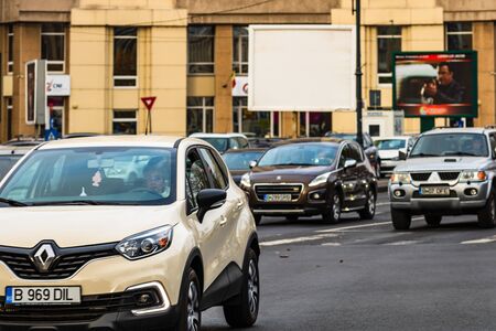 Traffic on the main boulevard in downtown Bucharest. Junction with stopped cars waiting for green light in Bucharest, Romania, 2019のeditorial素材
