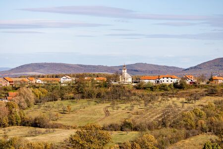 Cultivated land with village houses on the hill. Autumn season.の写真素材