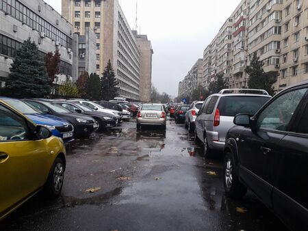 Cars parked along the street on a rainy day in Bucharest, Romania, 2019のeditorial素材