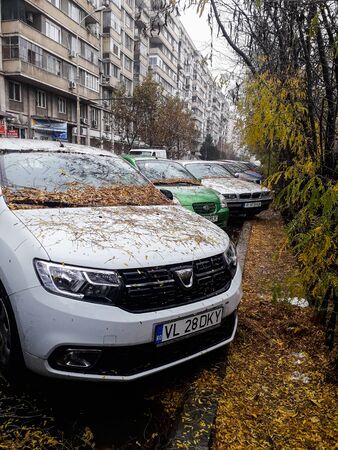 Rainy day in Bucharest. Autumn leaves on a parked car in downtown Bucharest, Romania, 2019のeditorial素材
