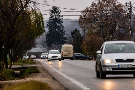 Cars in traffic on the asphalt road in Targoviste, Romania, 2019.のeditorial素材