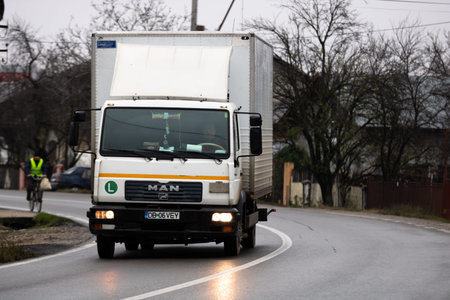 Commercial delivery truck on asphalt road in Targoviste, Romania, 2019.のeditorial素材