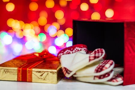 Christmas gift box, close up photo. Christmas composition on blurred lights background.の写真素材