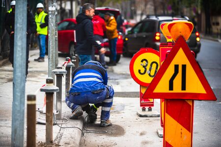Construction worker cutting asphalt paving stabs for sidewalk using a cut-off saw, diamond saw blade machine in Bucharest, Romania, 2019のeditorial素材