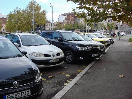 Cars parked along the street. Bucharest, Romania, 2019.のeditorial素材