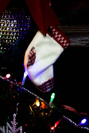 Christmas hanging decorations on fir tree. Decorated Christmas tree.  Fir branch with Christmas stocking.の写真素材