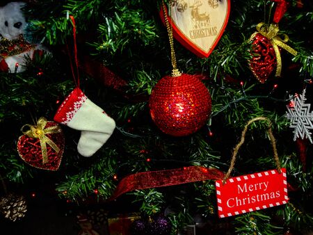 Christmas hanging decorations. Decorated Christmas tree with balls, garlands and lights. Fir branches with Christmas decorations.の写真素材