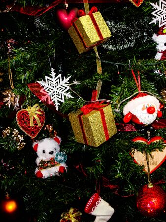 Christmas hanging decorations. Decorated Christmas tree with balls, garlands and lights. Fir branches with Christmas decorations.の写真素材