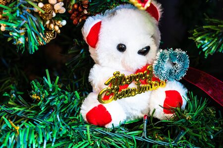 Christmas hanging decorations on fir tree. Decorated Christmas tree. Fir branch with Christmas bear toy.の写真素材