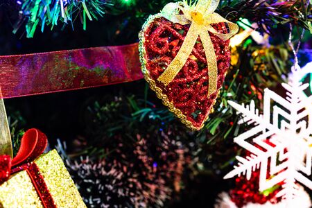 Christmas hanging decorations on fir tree. Decorated Christmas tree. Fir branches with Christmas decorations and garland.の写真素材