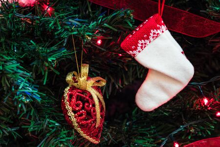 Christmas hanging decorations on fir tree. Decorated Christmas tree. Fir branches with Christmas decorations and garland.の写真素材