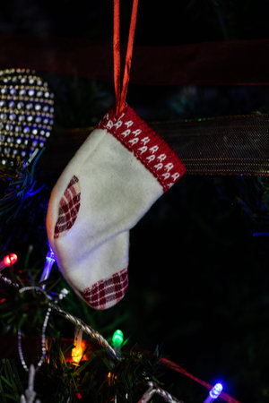 Christmas concept. Decorated Christmas tree,  Fir braches  with hanging decorations and garlands.