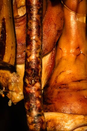 Traditional smoked pork meat products hanging in for sale at the winter Christmas market in Bucharest.の写真素材