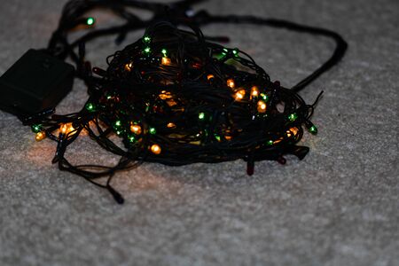 Electric lights need to be unraveled before decorating the christmas tree, isolated.の写真素材