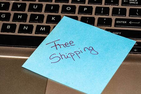 Writing on colorful sticky note Free Shipping. Text with Free Shipping on paper.の写真素材