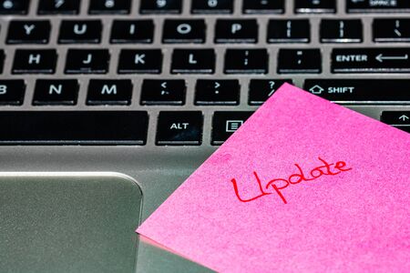 Writing on colorful sticky note Update. Text with Update on paper.の写真素材