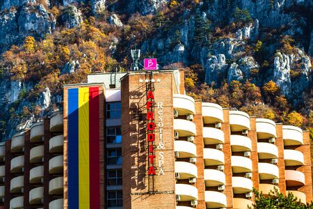 Imposing luxury hotel with spa and treatment base. Mountain and trees with yellow leaves during autumn. Afrodita Hotel , Herculane, Romania, 2019のeditorial素材