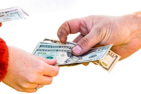 Hand giving money isolated, hard worked hand taking dollars money. Currency transfer on white background.の写真素材