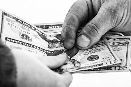 Hand giving money like bribe or tips isolated, hard worked hand taking dollars money. Currency...