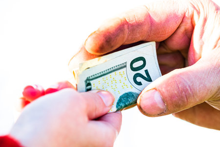 Hand giving money isolated, hard worked hand taking dollars money. Currency transfer on white...
