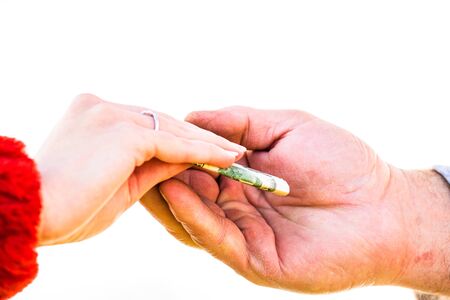 Hand giving money like bribe or tips isolated, hard worked hand taking dollars money. Currency transfer on white background. Reward for hard work.の写真素材