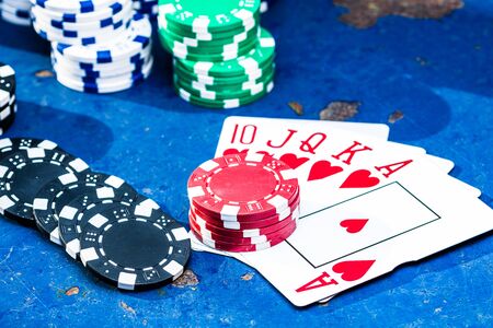 Poker game concept. Casino concept for business, risk,chance, good luck or gambling. Stack of Poker chips and playing cards, close up, isolated.の写真素材