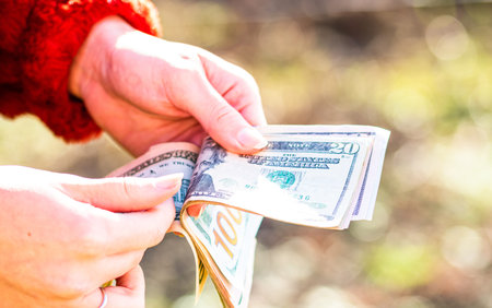 Woman counting money, counting dollars close up