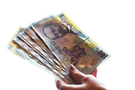 Woman hand giving money like bribe or tips isolated on white background. LEI currency banknotes close up. Reward for hard work, finance and business conceptの写真素材